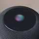 An image of the Apple HomePod with the Siri logo lit up.